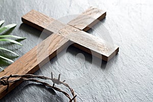 Easter wooden cross on black marble background religion abstract palm sunday concept