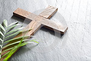 Easter wooden cross on black marble background religion abstract palm sunday concept photo