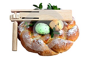 Easter wooden rattle - clapper - ratchet with eggs and sweet braided bread, homemade, isolated