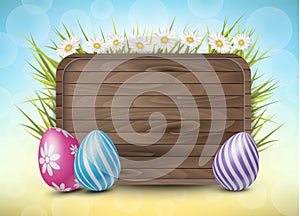 Easter wooden sign with painted 3d realistic eggs in green glass and flowers on yellow and blue bokeh backdrop.