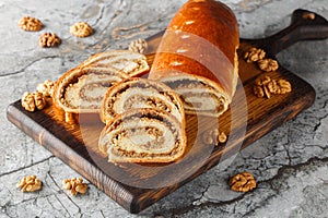 Eastern European Christmas and Easter nut roll made with ground walnuts closeup on the wooden board. Horizontal