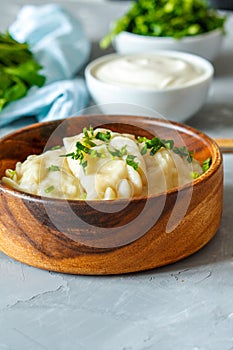 Eastern european dumplings, vareniki with sour cream with parsley