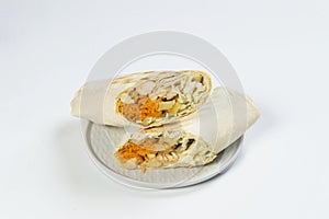 Eastern shawarma with chicken meat served on plate, isolated on background. Turkish donner wrapped in lavash bread