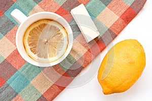 Eastern sweetness  fresh lemon and white cup with tea and lemon slice.