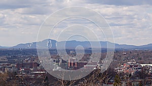 Eastern Townships small city Sherbrooke downtown mountain cloudy sky and buildings in Quebec Canada Estrie time lapse