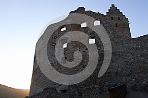 Eastern wall of early medieval inner courtyard of Topolcany castle during sunset.