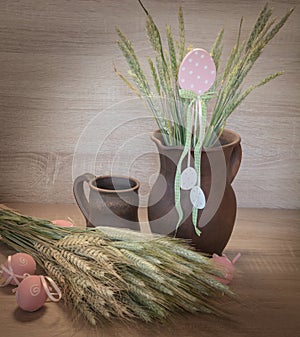 Easters still life from painted eggs, raw wheat