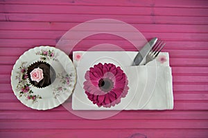 Easter time table place setting with chocolate cupcake and fresh flowers