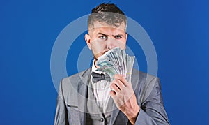 Easy cash loans. Man formal suit hold pile of dollar banknotes blue background. Businessman got cash money. Richness and