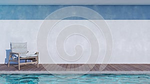 Easy chair with white towel on the side of swimming pool with rough white stucco paint wall. The light reflected on pool water,