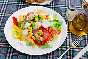 Salad with cheese, tomato, peppers, and corn