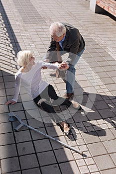 Easy going woman having painful accident on the street