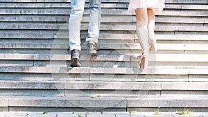 Easy-going young man and woman running upstairs in park, enjoying carefree life