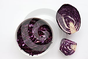 Easy homecooked coleslaw from red cabbage in a bowl and ingredients on white table background. Top view, copy space. photo