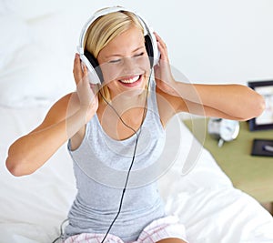 Easy listening. A young woman listening to music on her headphones.