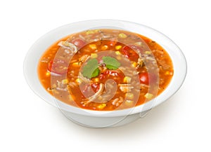 Easy Mexican chicken and rice soup in a white soup bowl isolated on a white background.