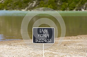 Easy money business symbol. Concept words Easy money business on beautiful black chalk blackboard. Beautiful mountain lake