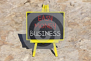 Easy money business symbol. Concept words Easy money business on beautiful black chalk blackboard. Beautiful red stone background