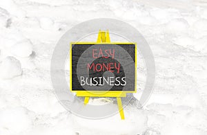 Easy money business symbol. Concept words Easy money business on beautiful black chalk blackboard. Beautiful white snow background