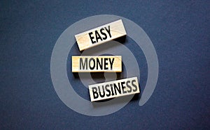 Easy money business symbol. Concept words Easy money business on beautiful wooden blocks. Beautiful black table black background.