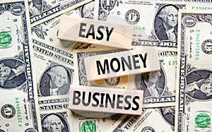 Easy money business symbol. Concept words Easy money business on beautiful wooden blocks. Dollar bills. Beautiful dollar bills