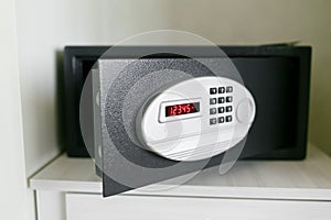 Easy password. Black safety box in hotel room. Concept safe storage of money and documents