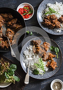 Easy peri-peri chicken livers and rice on a dark background, top view.