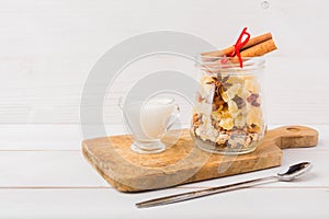 Easy quick breakfast with dryfruits, oatmeal and nuts in glass jar, ready for fill with milk