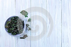 Easy three ingredient baked green kale chips with sea salt and olive oil, horizontal, copy space, top view