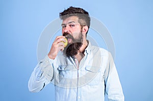 Eat apple can help lower blood sugar levels and protect against diabetes. Eat healthy. Man with beard hipster hold apple