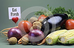 Eat Fresh message sign with fresh raw vegetarian food