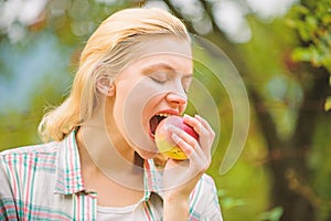 Eat fruits every day. Woman hold apple green garden background. Organic natural product. Girl gather apple harvest in
