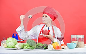 Eat healthy. Healthy ration. Girl wear hat and apron try mushroom taste. Woman professional chef hold spoon with raw