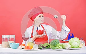 Eat healthy. Healthy ration. Girl wear hat and apron try mushroom taste. Woman professional chef hold spoon with raw