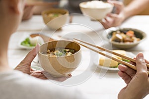 Eat miso soup with chopsticks photo