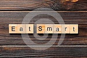 Eat smart word written on wood block. Eat smart text on wooden table for your desing, Top view concept