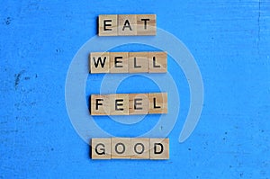 eat well feel good text in wooden square, motivation quotes.