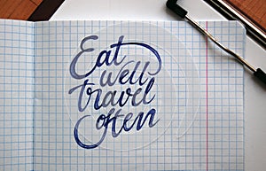 Eat well and Travel often calligraphic background photo