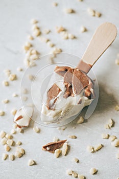 Eaten chocolate almond ice-cream on a wooden stick.Top view