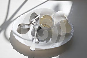 Eaten soft-boiled eggs in elegant plate with teaspoons. morning meal under the sun from window