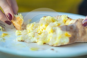 Eating Adjarian khachapuri with eggs on the table