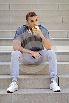 Eating banana fruit runner young man portrait format sports training fitness