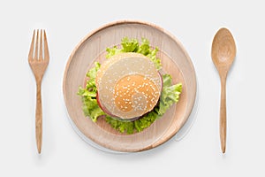 Eating bbq burger on wooden dish isolated on white background.