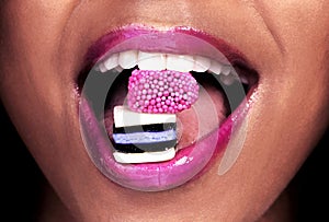 Eating, candy and woman with makeup for mouth, color and lipstick closeup. Skin, shine and girl with liquorice for