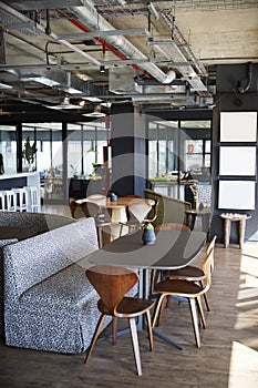 The eating and casual meeting area at a creative office in daylight, no people, vertical