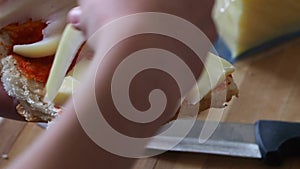 Eating cheese between bread, preparing a quick snack at home, cheddar cheese and bread