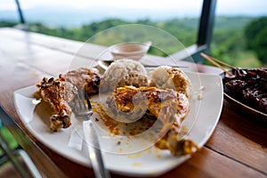 Eating chicken inasal and isaw while enjoying the overlooking view of Rizal, Philippines