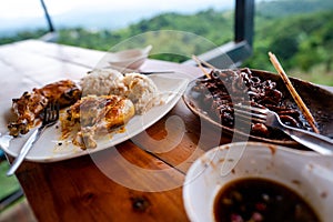 Eating chicken inasal and isaw while enjoying the overlooking view of Rizal, Philippines