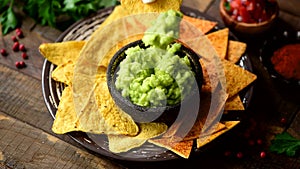 Eating corn chips nachos with guacamole