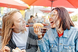 Eating Currywurst fast food German sausage in outdoor street food cafe